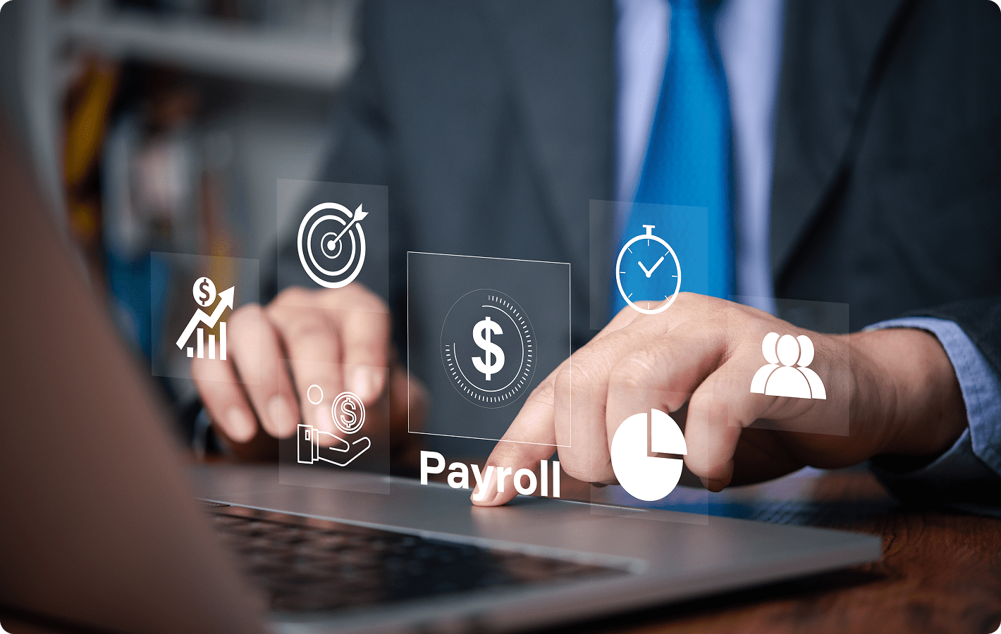 Man typing with payroll and finance icons.