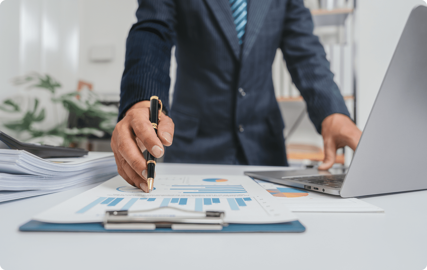 Businessman analyzing financial charts and graphs.