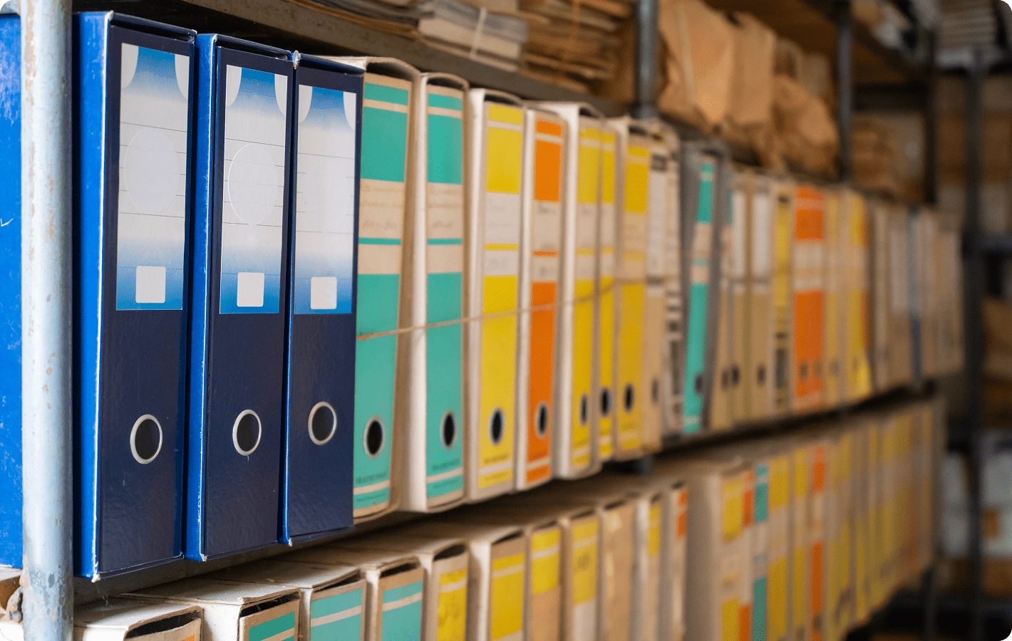 Colorful binders neatly arranged on shelves.