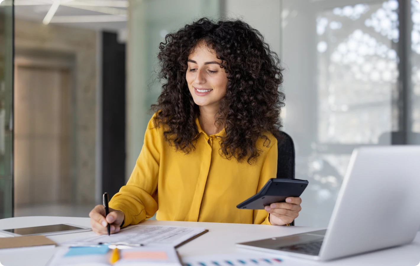 Smiling woman working at a desk.